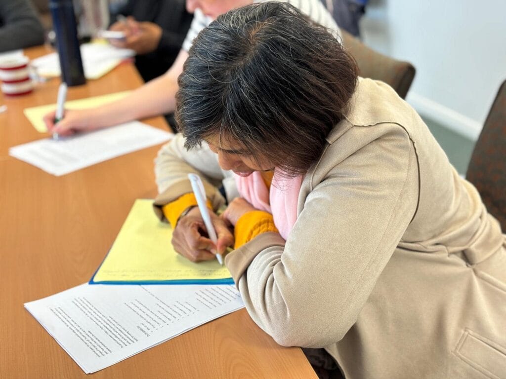 Woman concentrating writing.