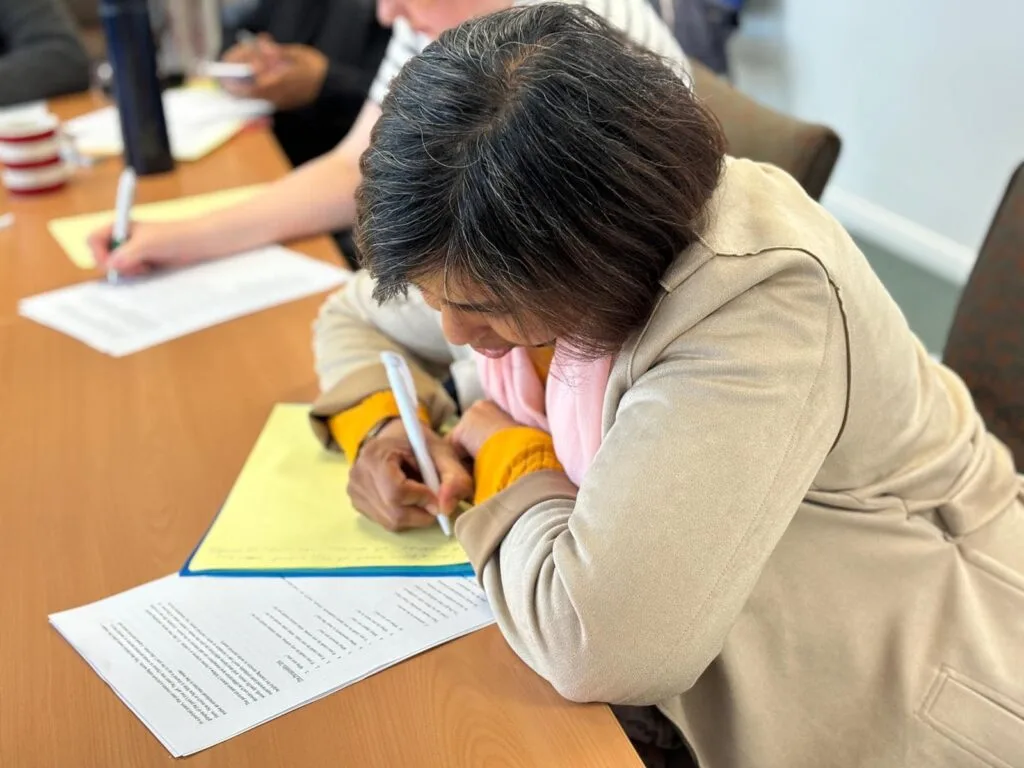 Woman concentrating writing.