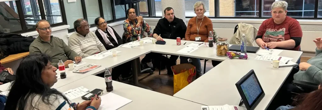 People gathered around table for meeting.