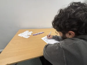 Person filling out form for Autism Alert card.